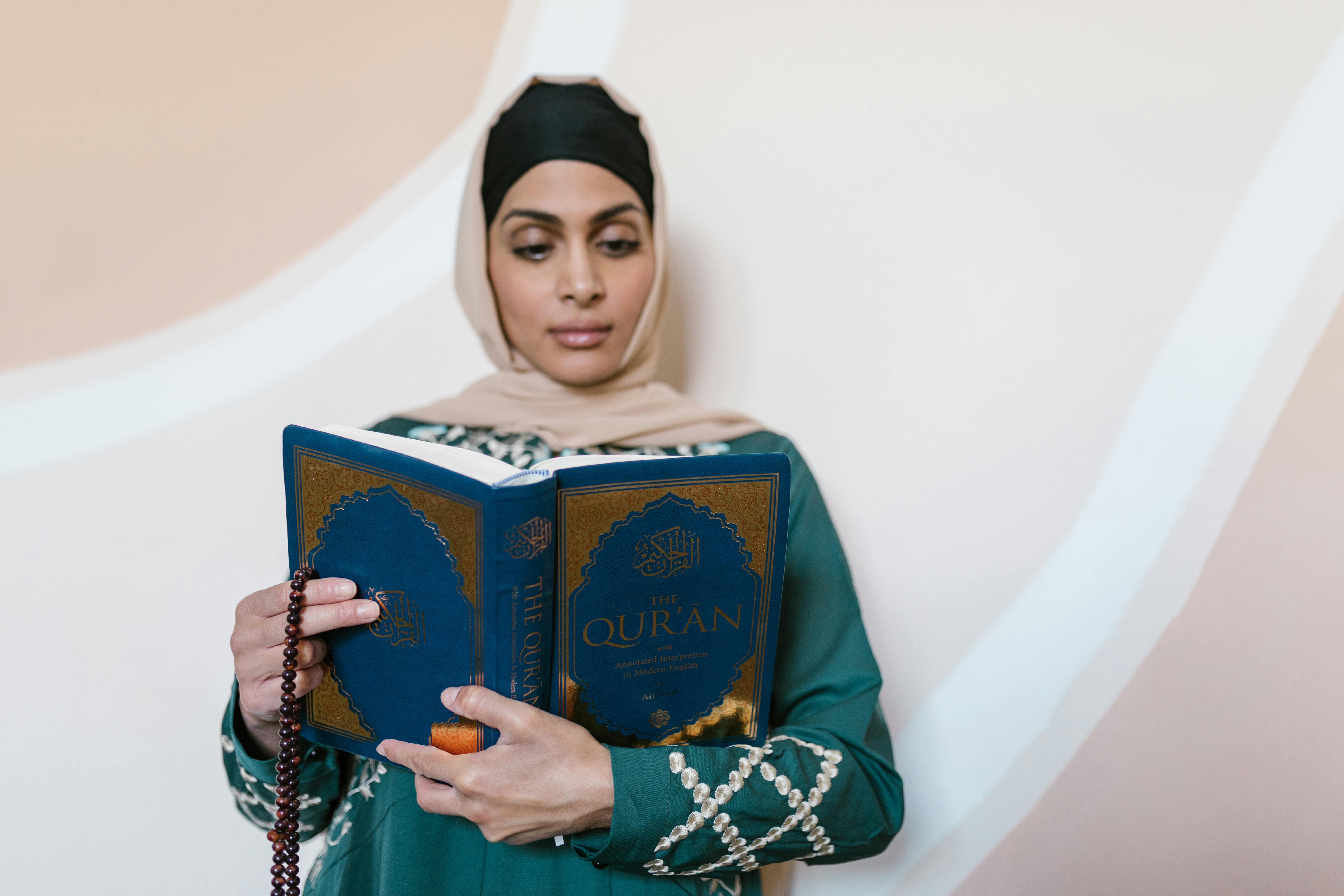 A Woman In Black And Beige Hijab Holding The Quran And Misbaha · Free ...