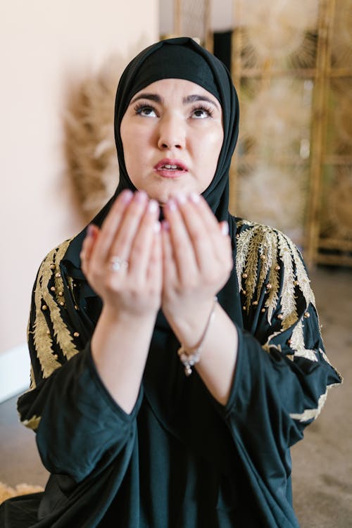 Photo of a Woman Praying while Looking Up