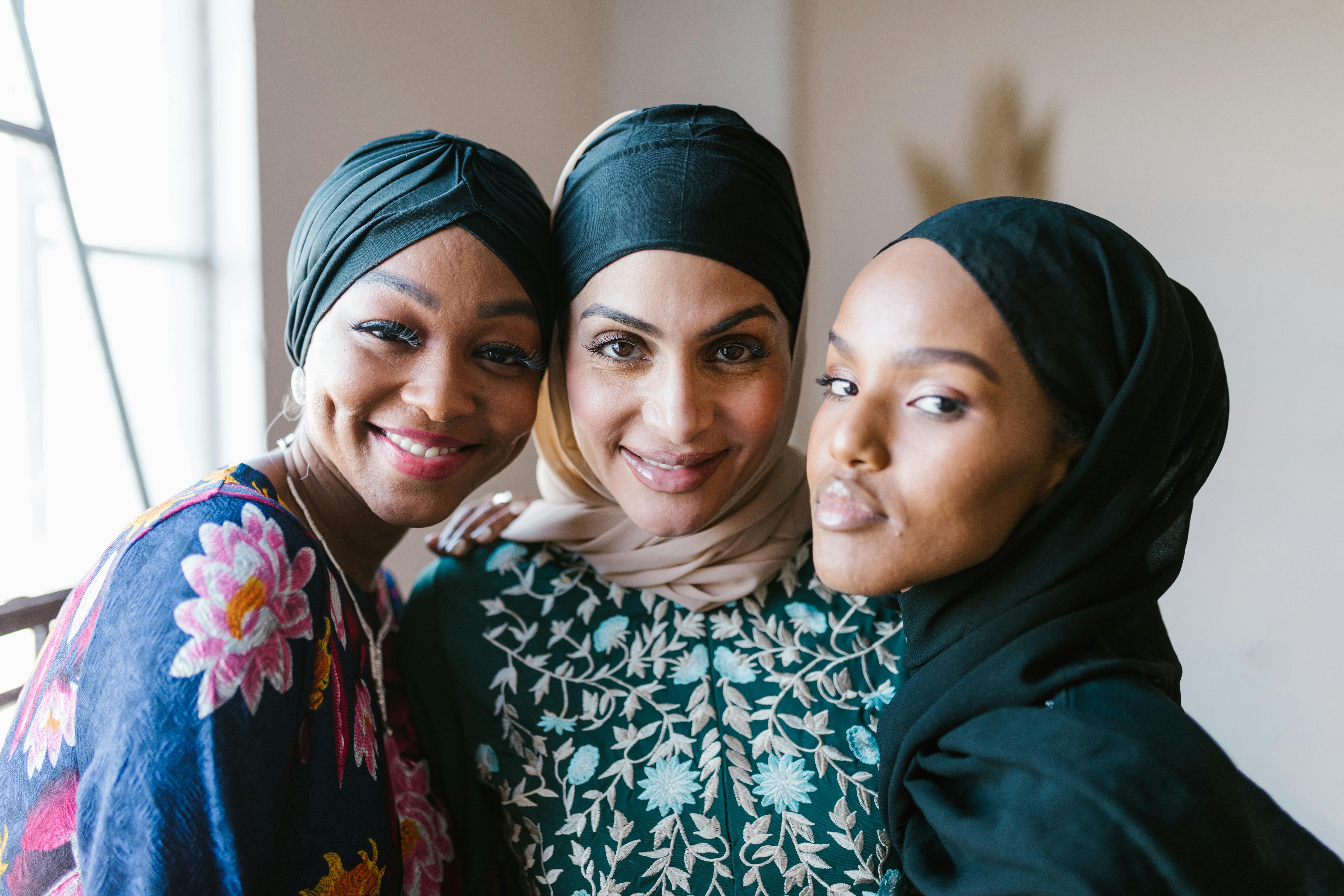 2 women smiling wearing hijab