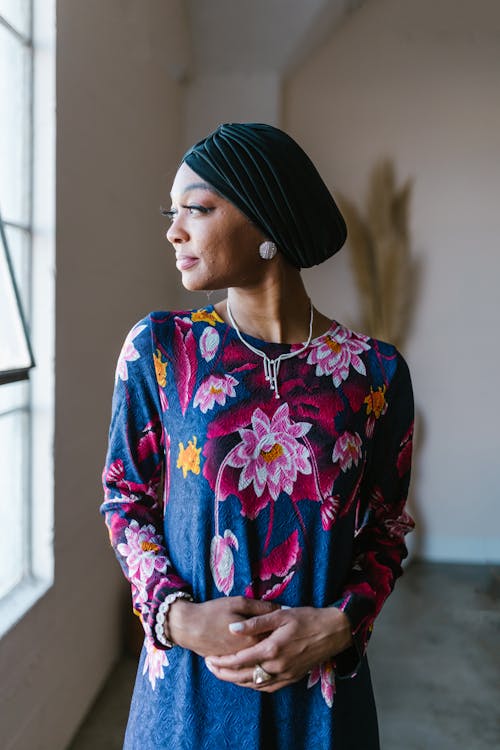 A Woman in Blue and Yellow Floral Long Sleeve Dress Wearing a Black Hijab