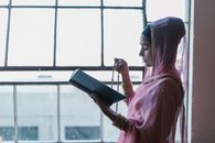 Woman in Pink Hijab Holding Black Tablet Computer
