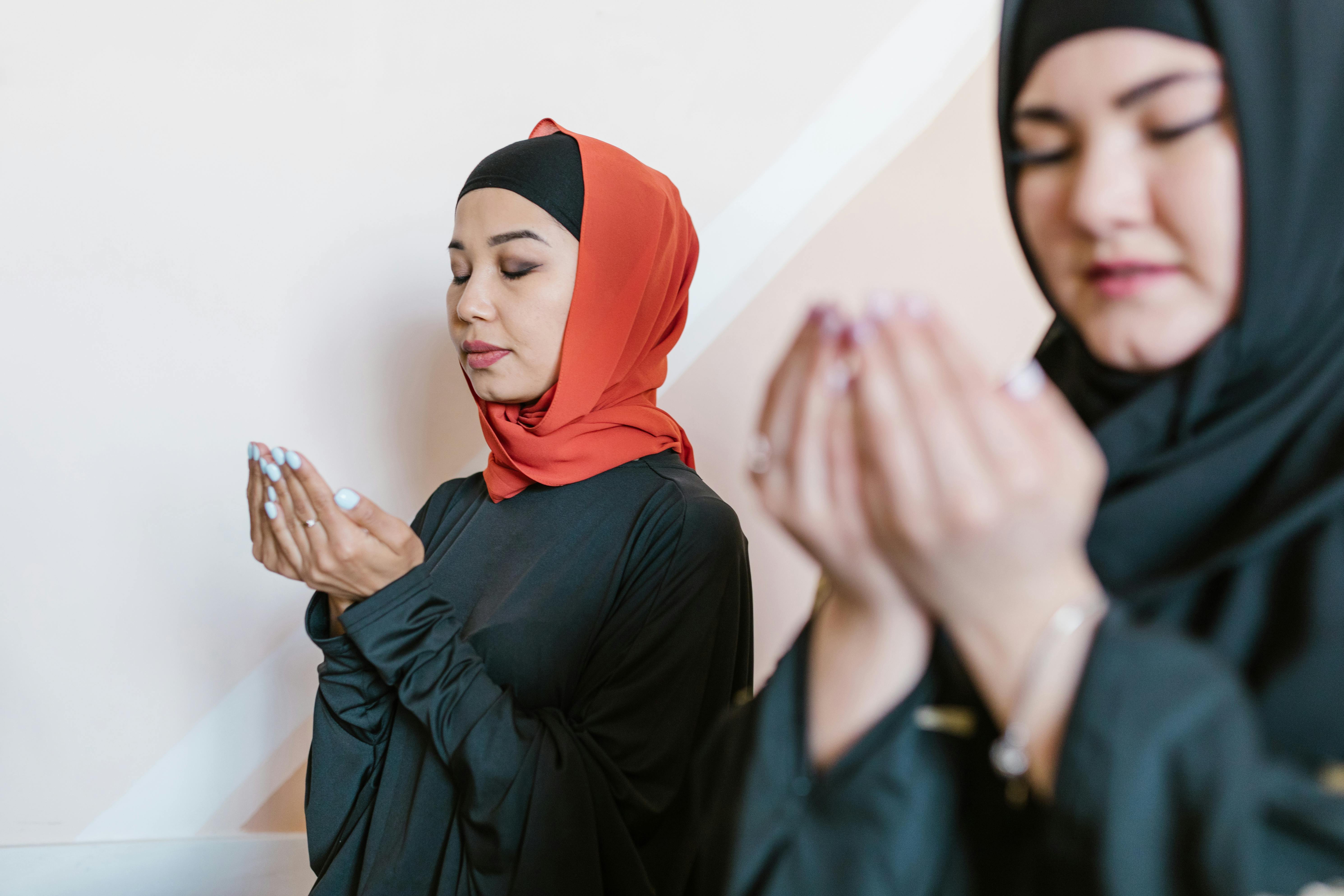 woman in black long sleeve shirt wearing red hijab