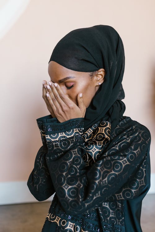 Free Woman in Black Hijab Covering Face With Hand Stock Photo
