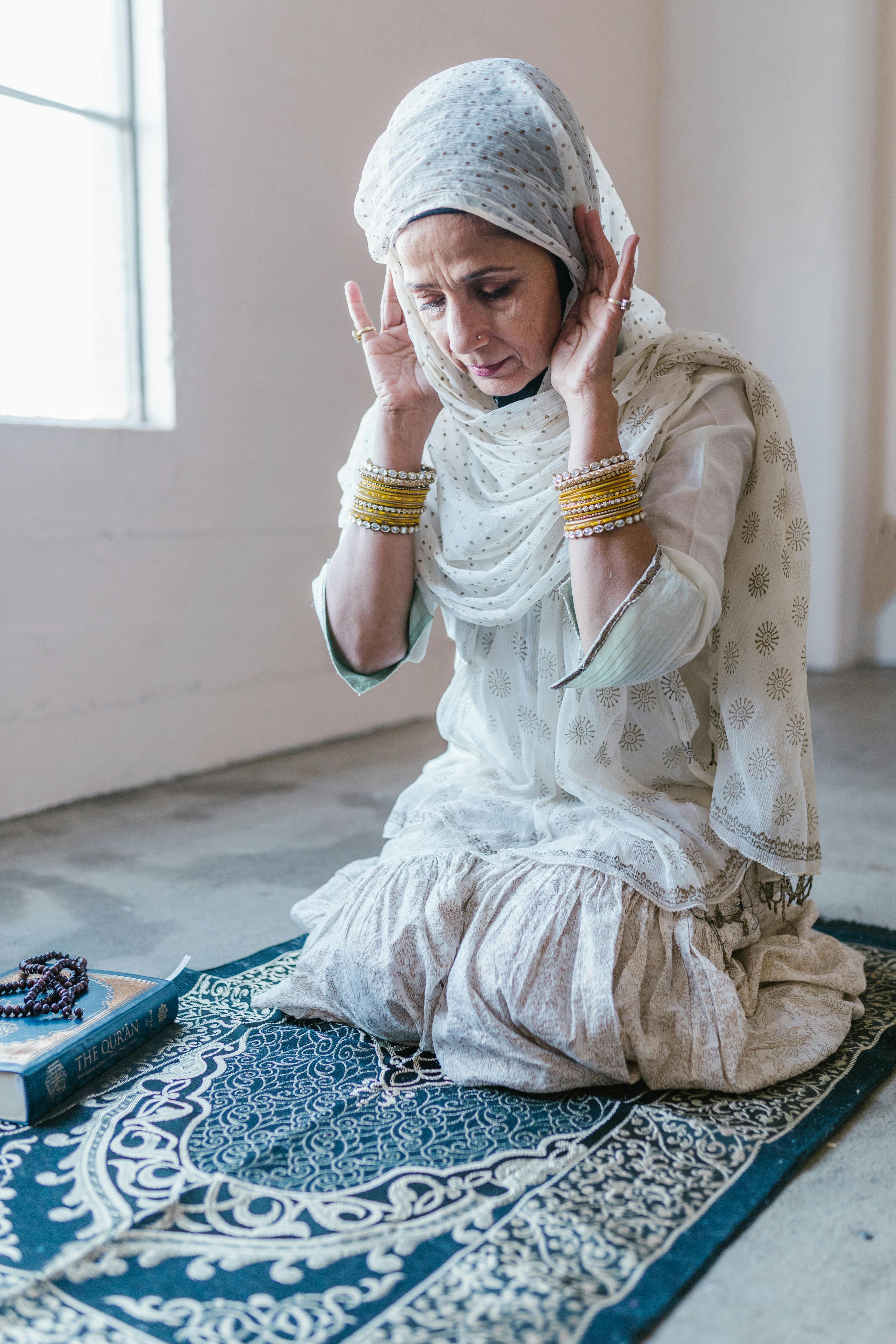 woman in white dress kneeling on floor