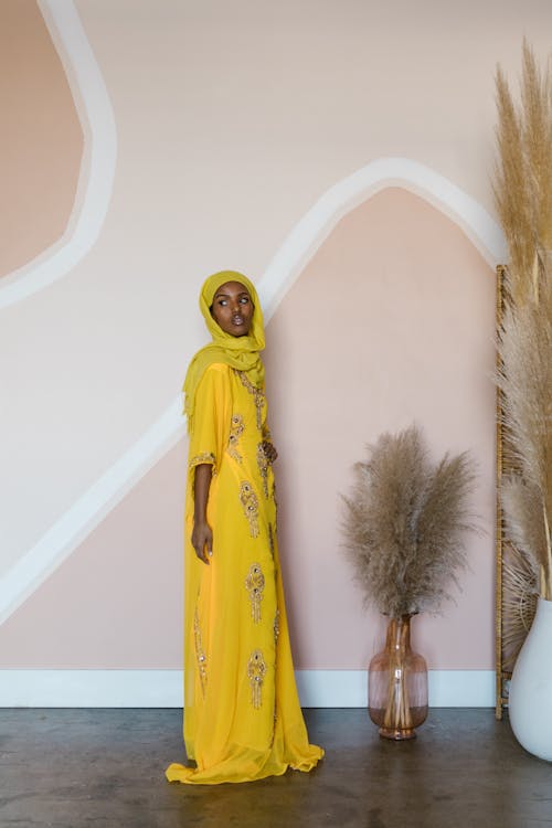 Woman Wearing a Yellow Hijan and Traditional Dress