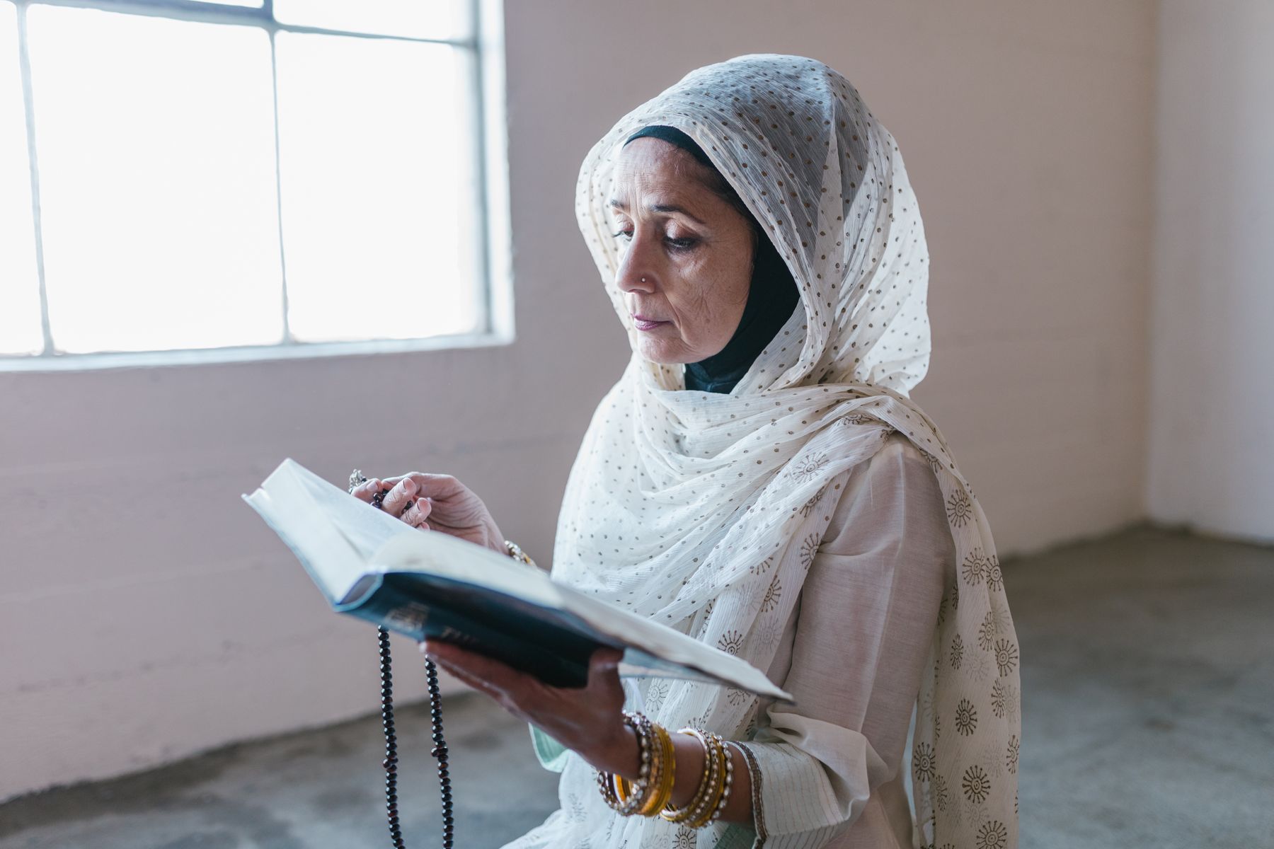 Muslim woman reading Quran