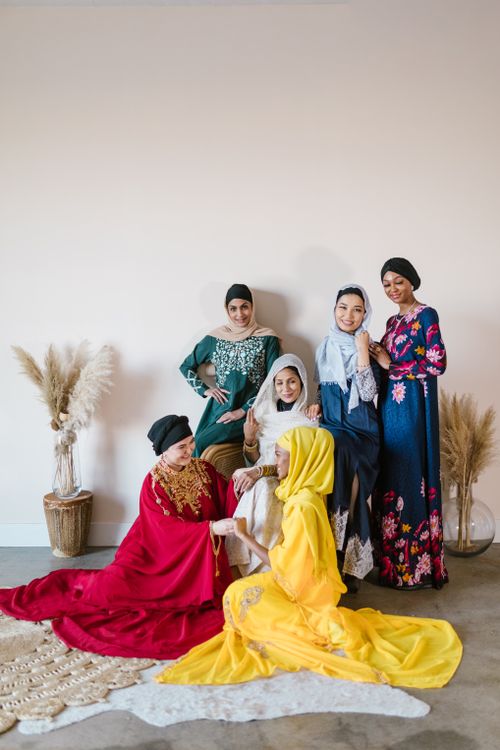 Free Group portrait of women in colorful dresses and hijabs, showcasing cultural diversity. Stock Photo