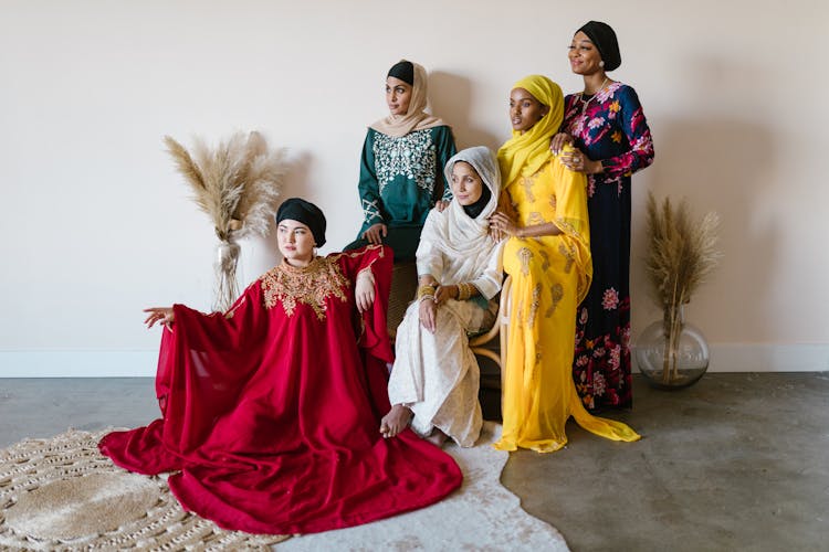 A Group Of Women In Dresses Wearing Hijabs