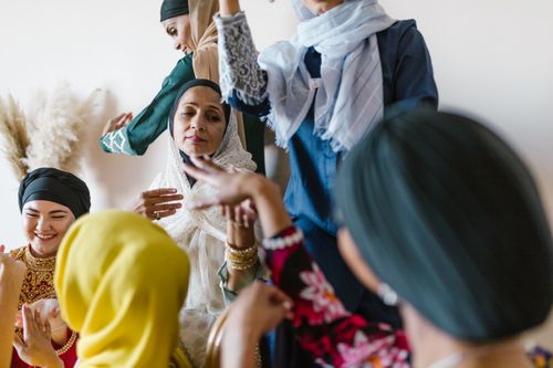 Free Group of diverse Muslim women in colorful attire celebrating and enjoying each other's company. Stock Photo