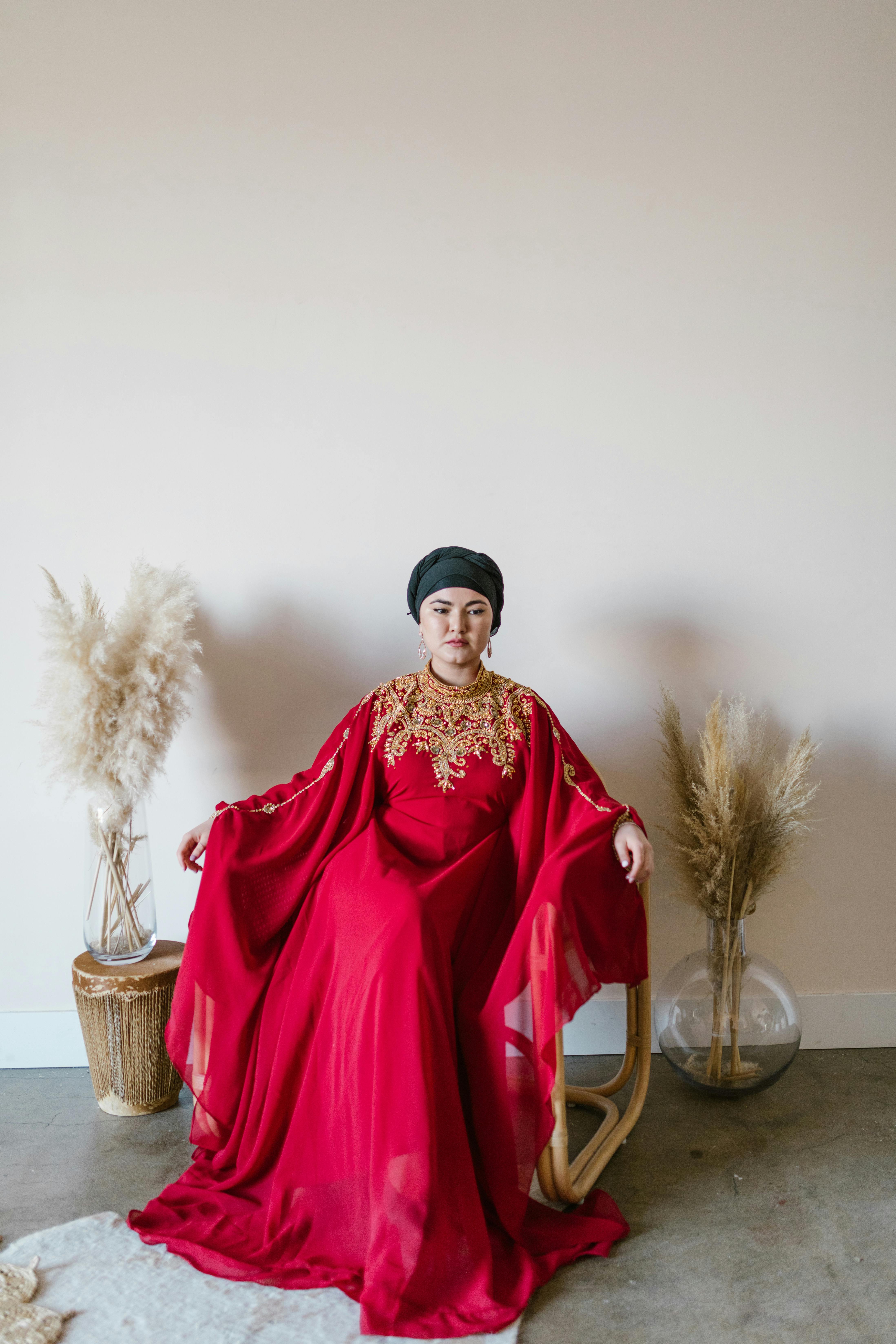 woman in red dress sitting on brown wicker basket