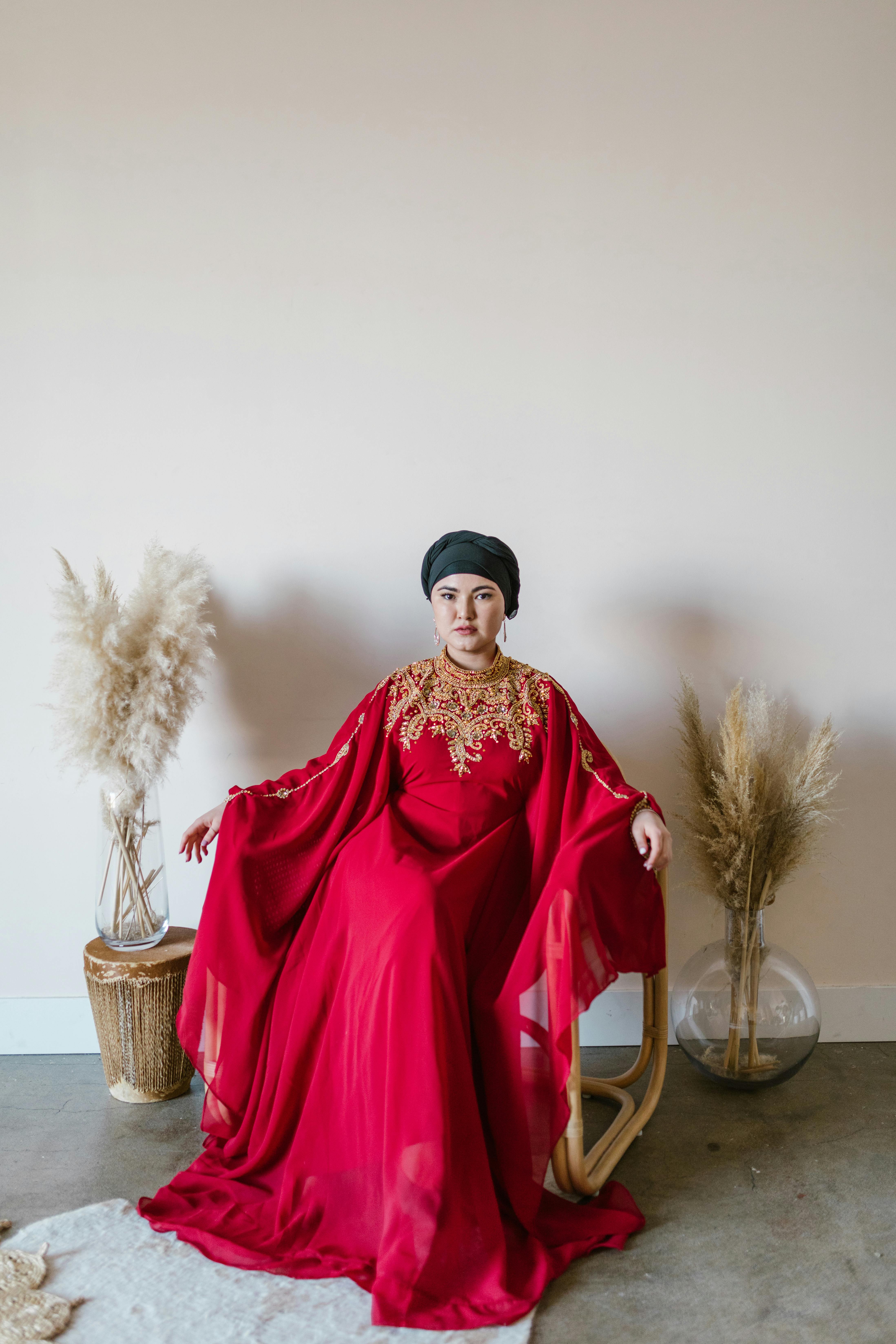 woman in red long sleeve dress standing beside brown wicker basket