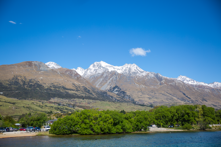 Unbeatable 50-Minute Glacier Explorer & Earnslaw Burn Flight, Queenstown Review Review 2026 - Captivating view of snow-capped mountains and lush greenery under a bright blue sky.