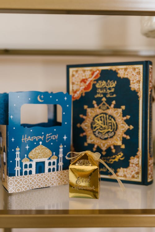 Free Gift Boxes And Holy Book On Table Stock Photo