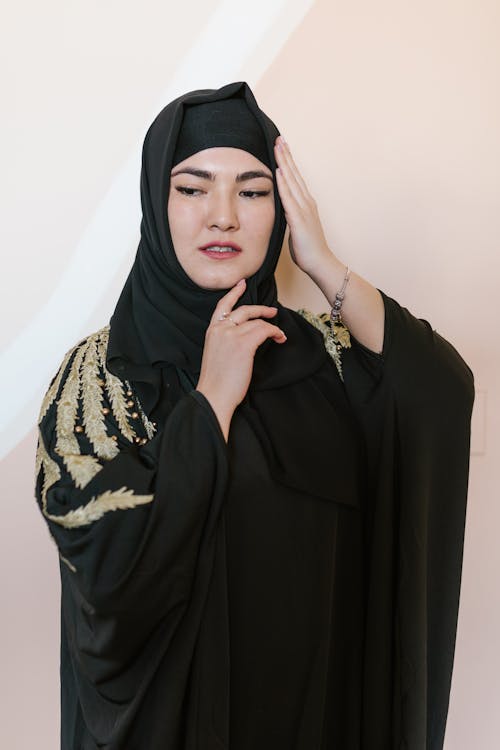 Woman in Black Hijab and Black and Gold Traditional Dress