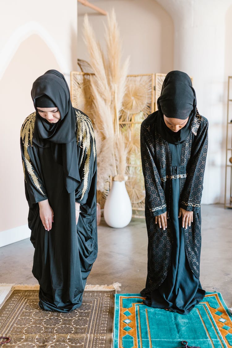 OwnWomen Wearing Black Hijab And Bowing Down