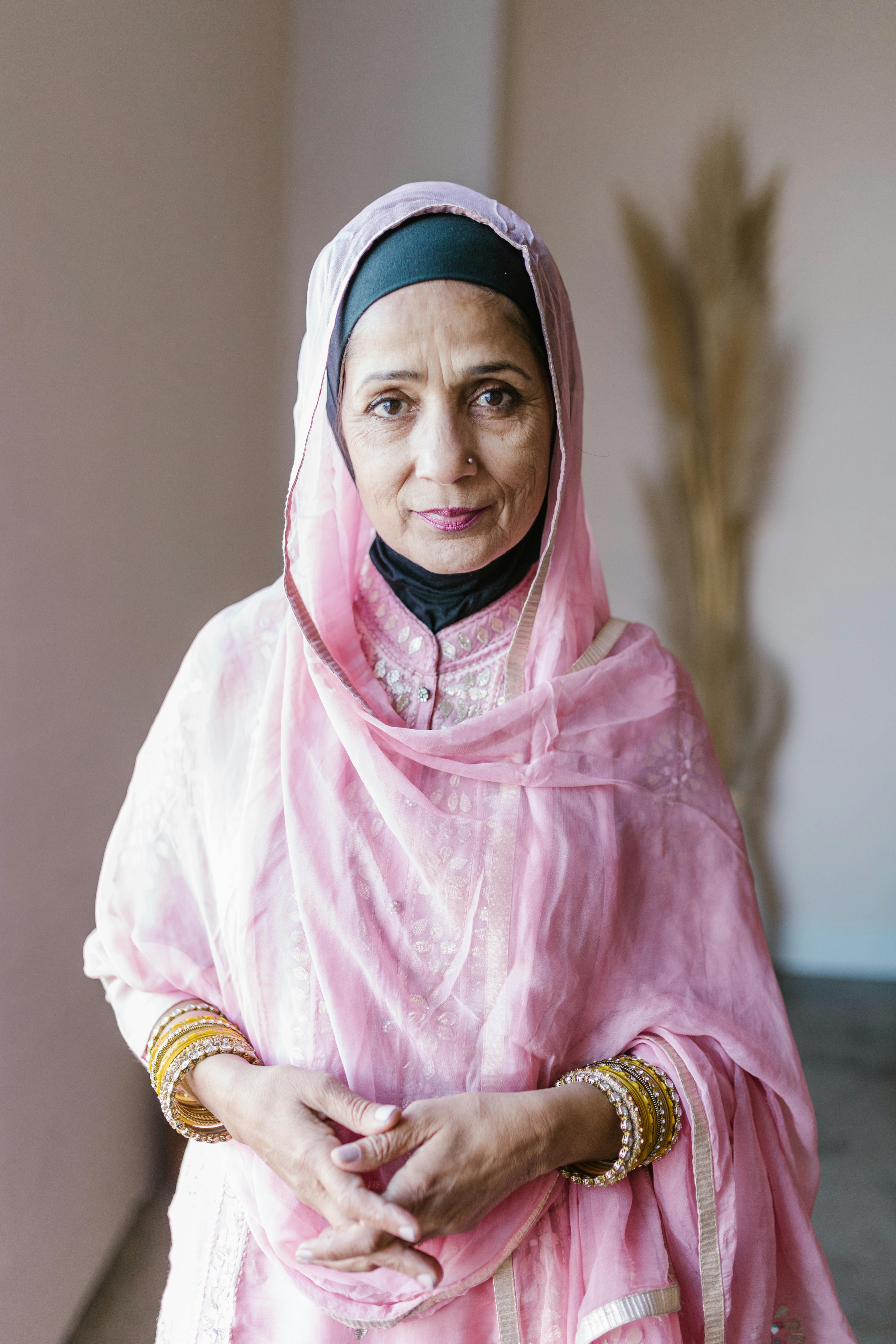 A beautiful portrait of a senior woman in traditional attire with a serene expression.