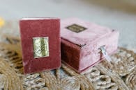 Red and Gold Book on Brown Textile