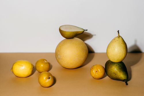 Free A composition of pears and citrus fruits in a minimalist still life photography setting. Stock Photo