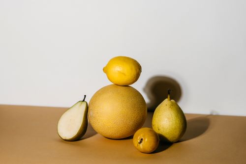 Free Still life of assorted fruits including melon and pear with shadow effect. Stock Photo