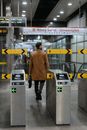 A Man in Brown Coat Entering a Train Station