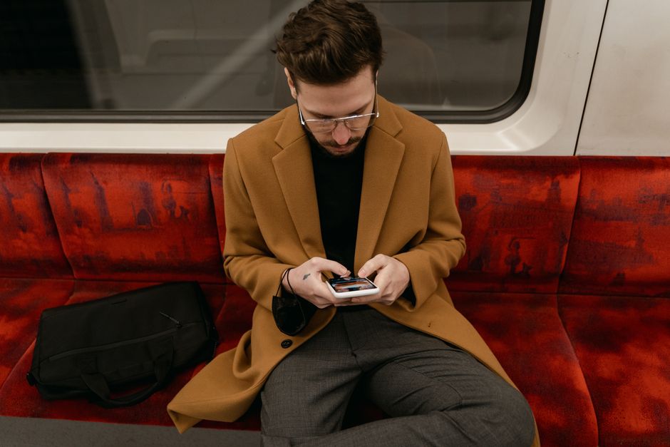 Philadelphia commuter using a mobile-optimized online store on a train Philadelphia commuter using a mobile-optimized online store on a train