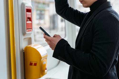 Person Using a Smartphone While Riding a Train  