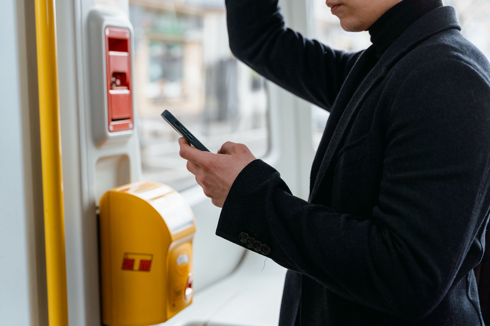 Person Using a Smartphone While Riding a Train