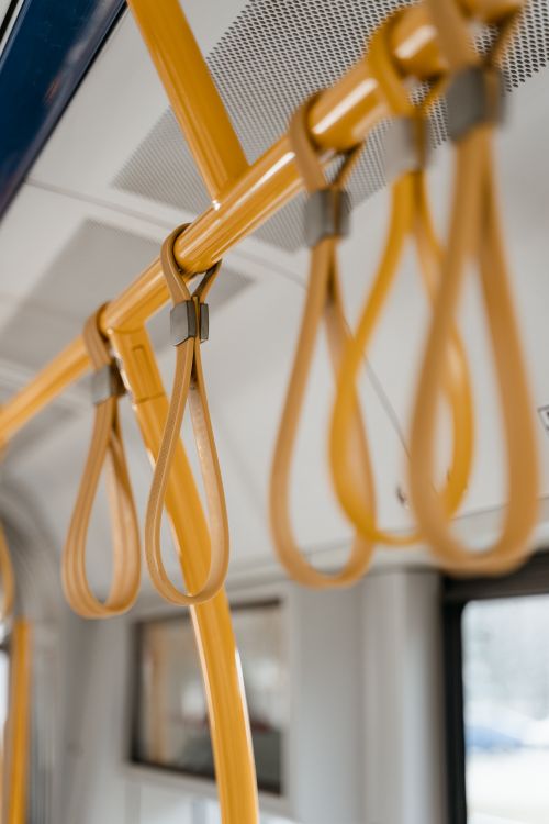 Free Detailed view of yellow handrails on a public bus, showcasing urban commute elements. Stock Photo