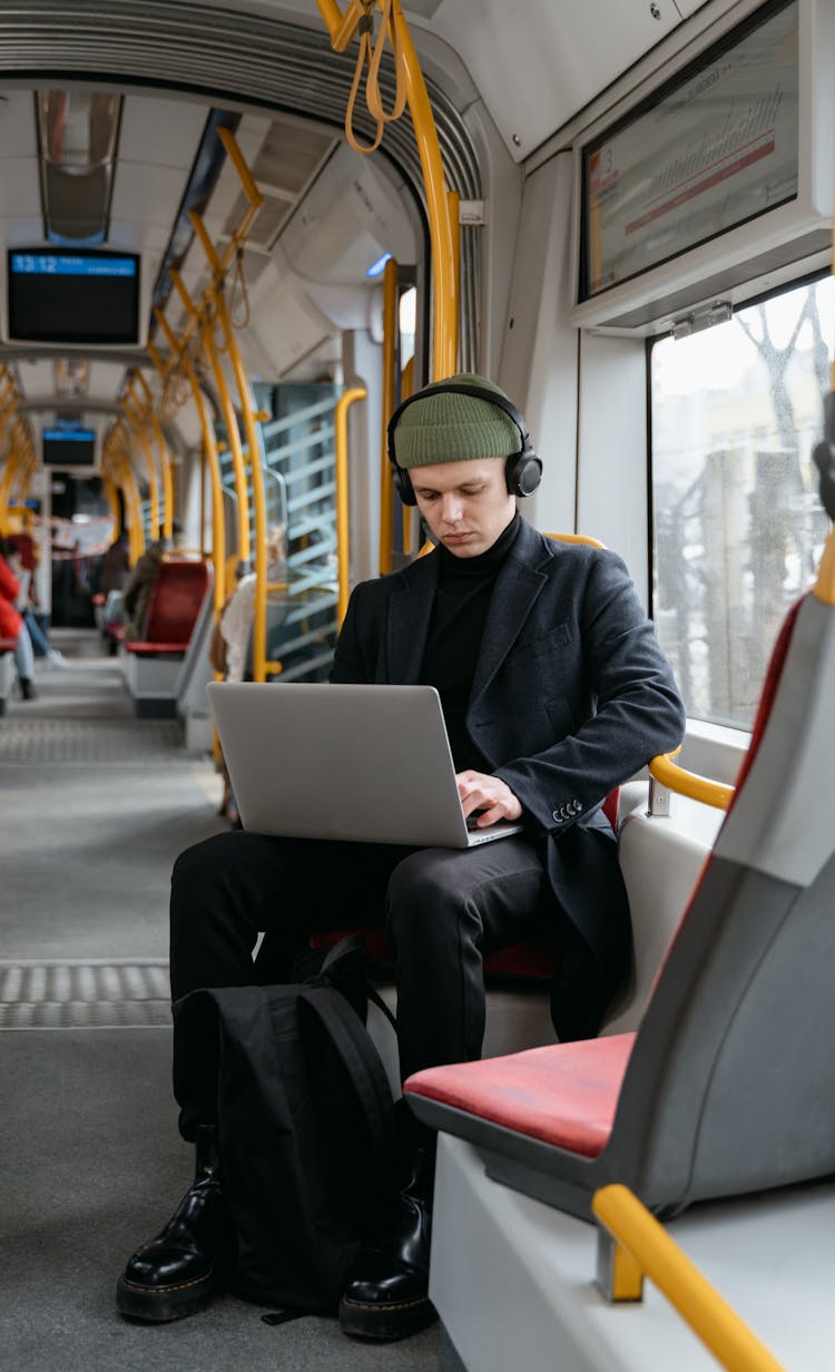 Man In Black Clothes Using Laptop While In The Train