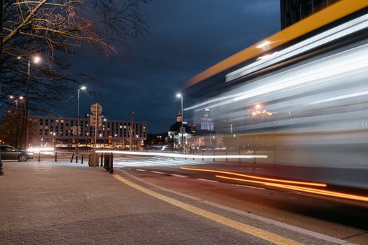 Nighttime city scene with blurred lights from traffic, capturing urban energy.