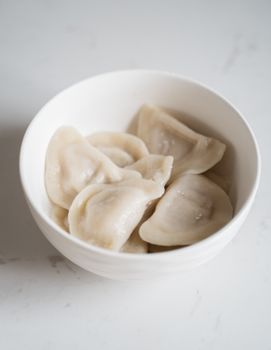 Delicious steamed dumplings served in a white bowl, perfect for food enthusiasts.
