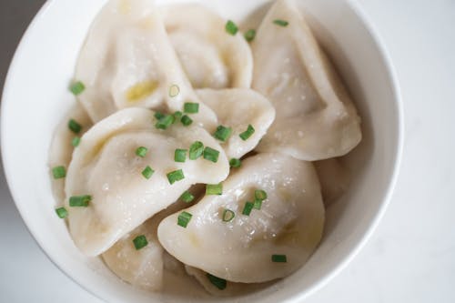 Free Steamed Dumplings with Onion Leeks in a Ceramic Bowl Stock Photo