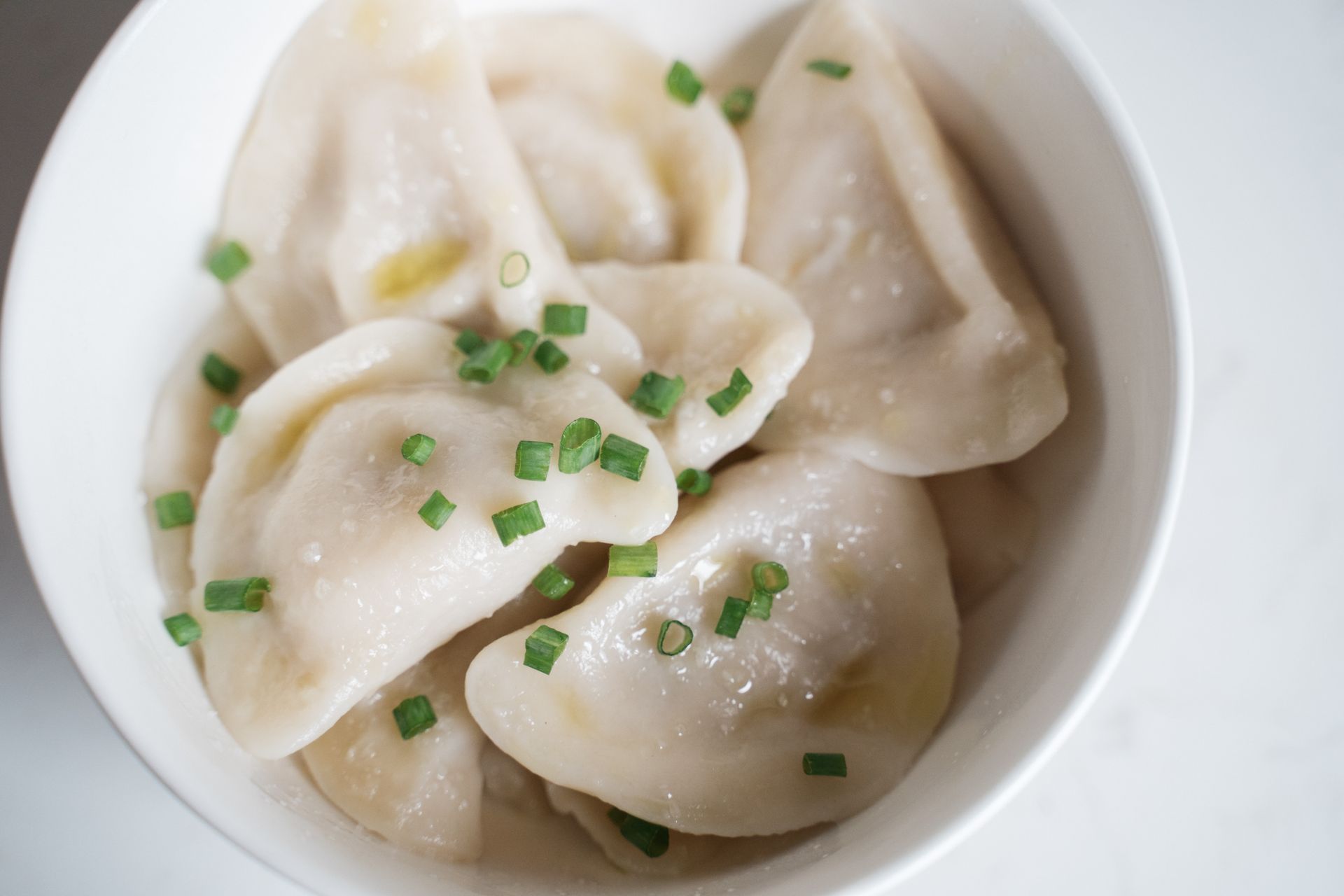 Steamed Dumplings with Onion Leeks in a Ceramic Bowl