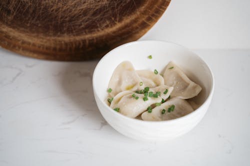 Free Close-Up Shot of Raw Dumplings in a Bowl Stock Photo