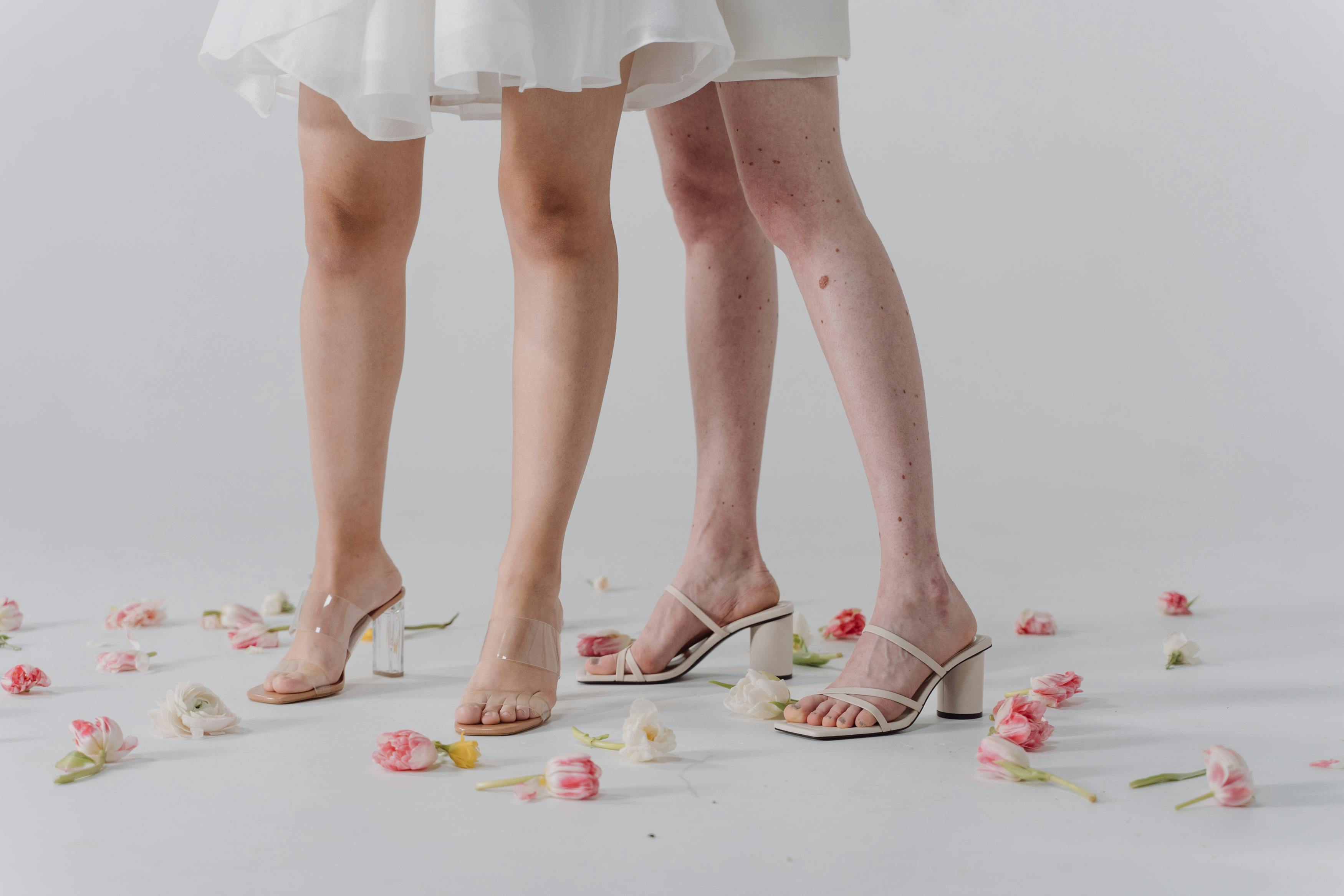 two women wearing heeled sandals
