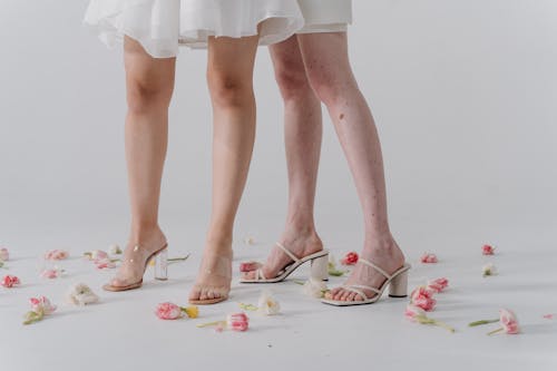 Two Women Wearing Heeled Sandals 