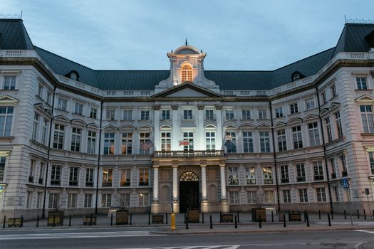 Twilight view of the Renaissance Revival Jablonowski Palace facade with illuminated details.