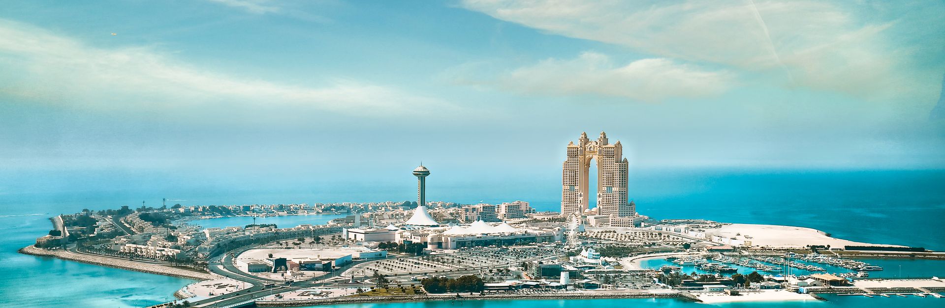 Stunning aerial cityscape of Abu Dhabi's waterfront and skyline on a clear day.