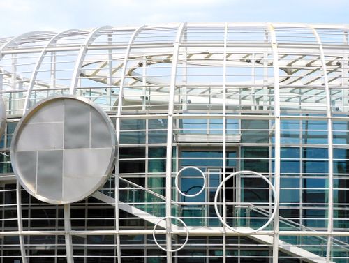 Free Top of contemporary glass building with creative white lattice and glass walls reflecting daylight Stock Photo