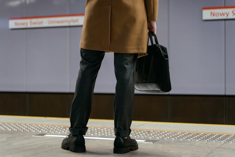 Photograph Of A Person With A Black Briefcase