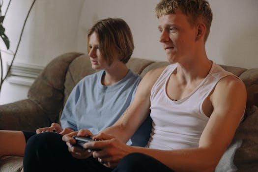 A couple immersed in video gaming on a cozy couch at home.