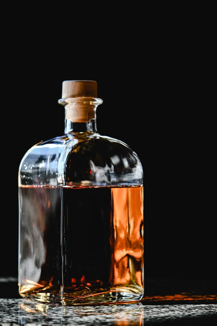 Clear Glass Bottle With Brown Liquid