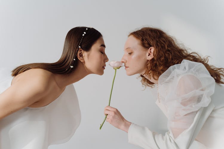 Women Smelling A Flower