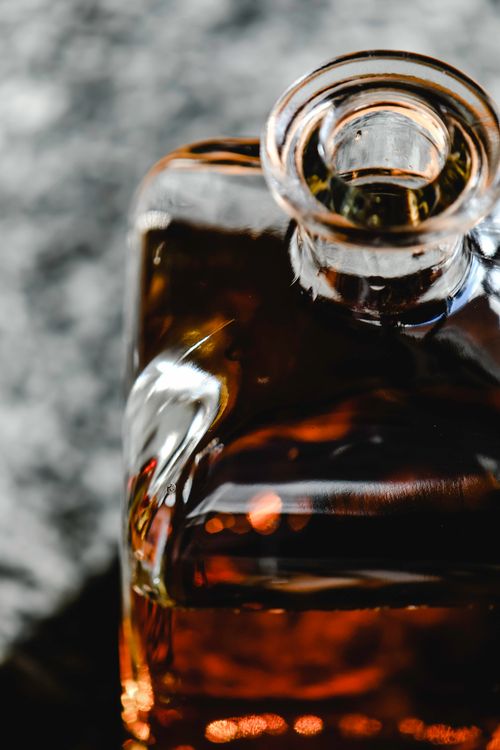 Free Close-up view of a whiskey bottle showcasing its elegant design and color. Stock Photo