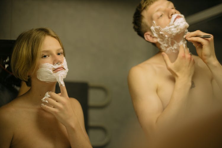 A Shirtless Boys With Shaving Cream On Their Face