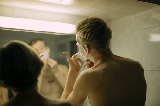 Two men shaving in a bathroom, focusing on hygiene and morning routine.