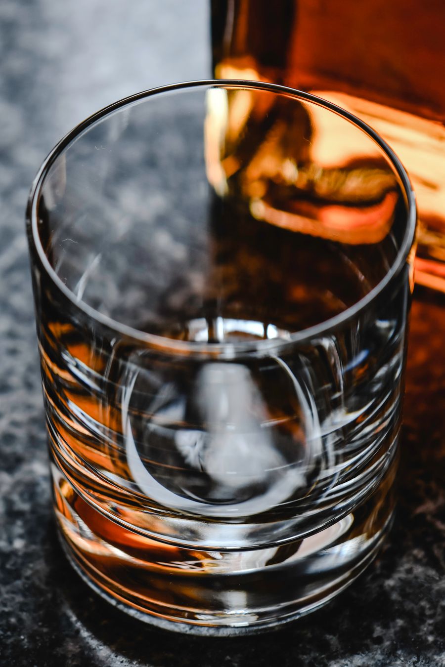 Empty whisky glass on granite surface