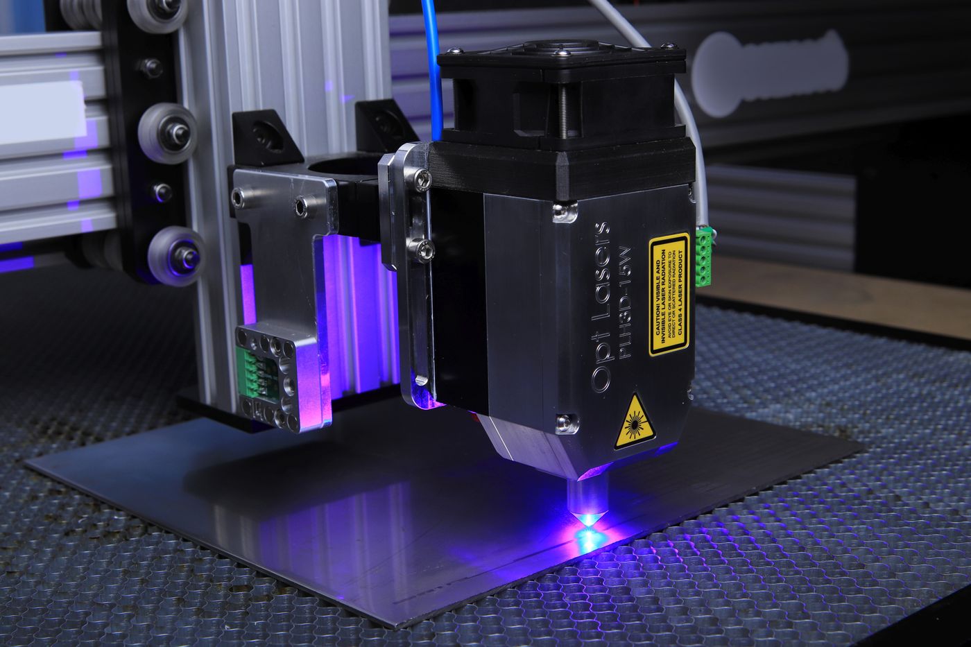 Laser engraving machine etching metal under blue light