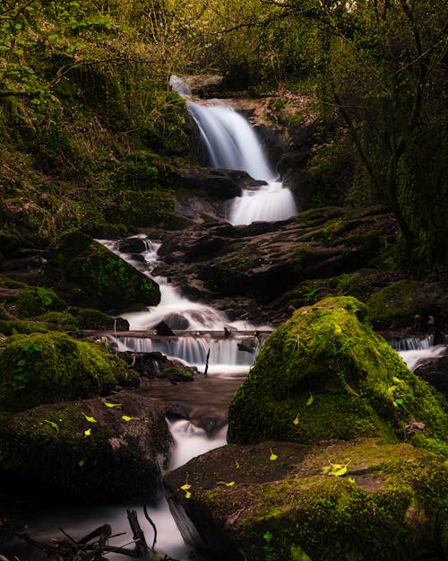  A Nature Photography of a Cascading Waterfalls from a Rocky Ledge