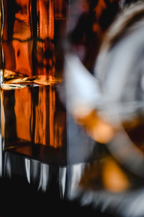 Close-Up Photo of a Glass Bottle with Whiskey